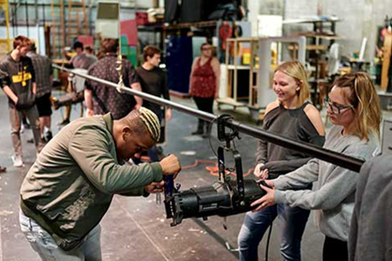 students working with lighting for a cinema production